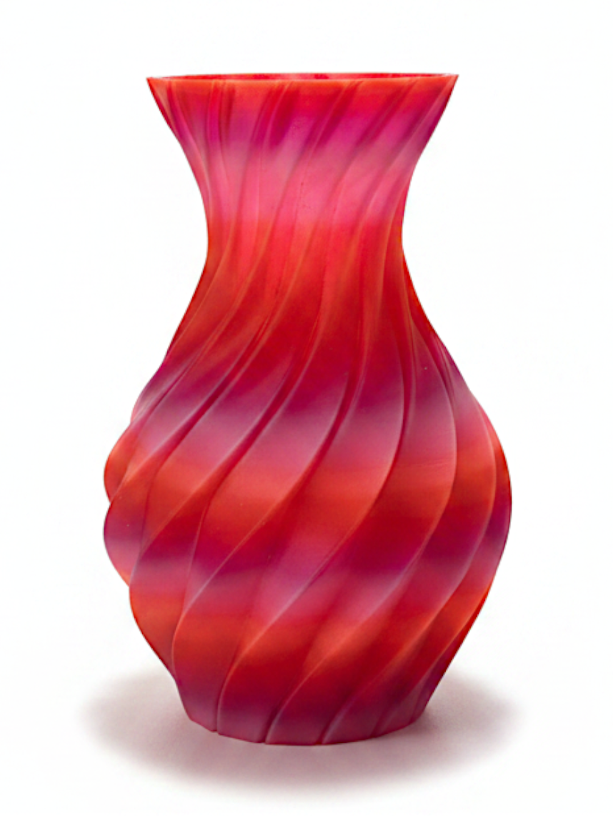JT-PRINT-SERVICE Sunset Twisting Pillars Vase with a spiral ribbed design in gradient orange, red, and hot pink PLA.