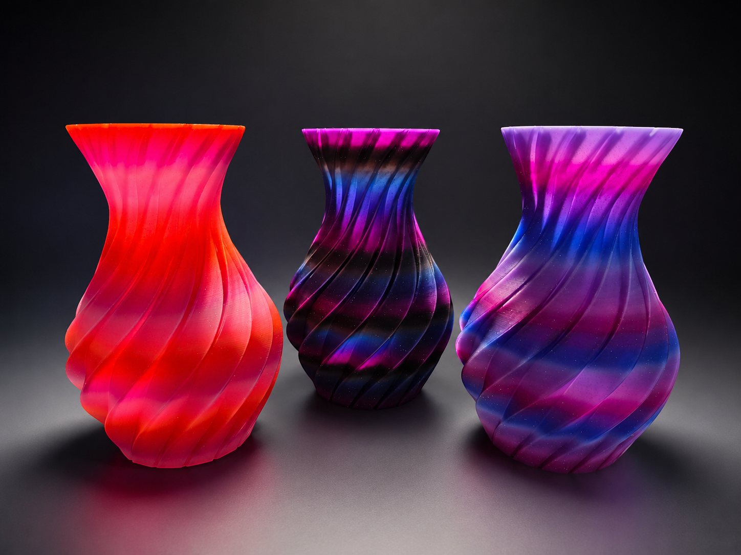 JT-PRINT-SERVICE 3D printed twisting pillar vases in Sunset, Dark Galaxy, and Nebula gradient colorways.